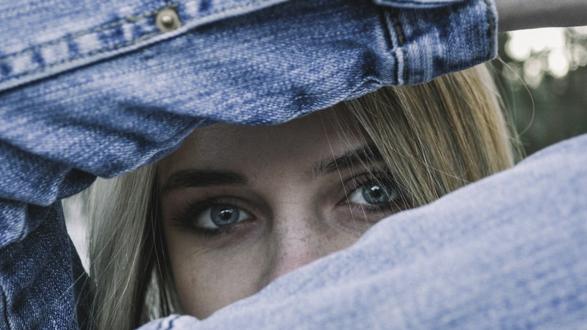 selective focus photography of woman wearing blue denim jacket